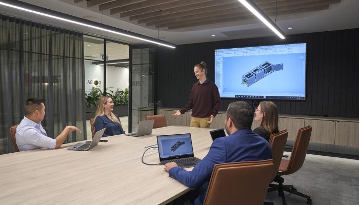 Office workers sitting at a table in a meeting