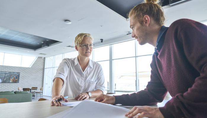 A male and female colleague talking to each other