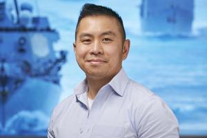 Person standing in front of screen with ships