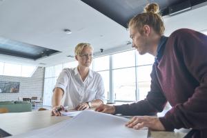 A male and female colleague talking to each other